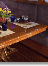 Teak dining table J.T. John created to match existing design elements elsewhere on the yacht,  including radiused corners and lamb's tongue details. Photo by Neil Rabinowitz; yacht restoration by Tom George.