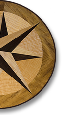 This compass rose out of solid wood lies in the top of an oval table J.T. John designed for a yacht based in Washington. It features Peruvian walnut, quilted maple, and “figured” teak, all in a field of teak.