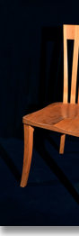 Cherry chair designed by J.T. John to accompany one of his dining tables.  The deep, sculpted seats and tall, curved backs enable people of various sizes to sit comfortably for hours.