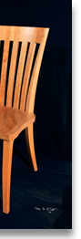 Cherry chair designed by J.T. John to accompany one of his dining tables.  The deep, sculpted seats and tall, curved backs enable people of various sizes to sit comfortably for hours.